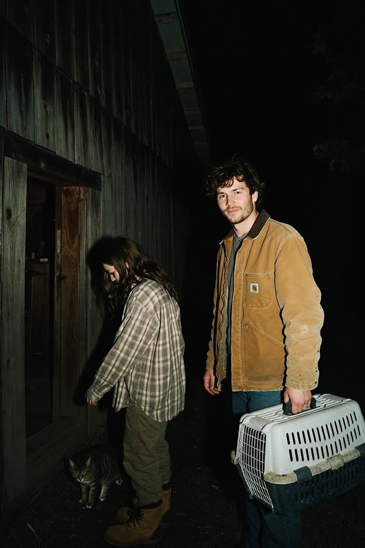 Us at the barn at night with a tabby cat and a cat carrier